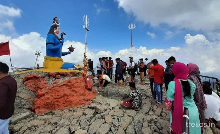 Prayer flags and the Shirgul temple near the Churdhar summit with the Himalaya beyond