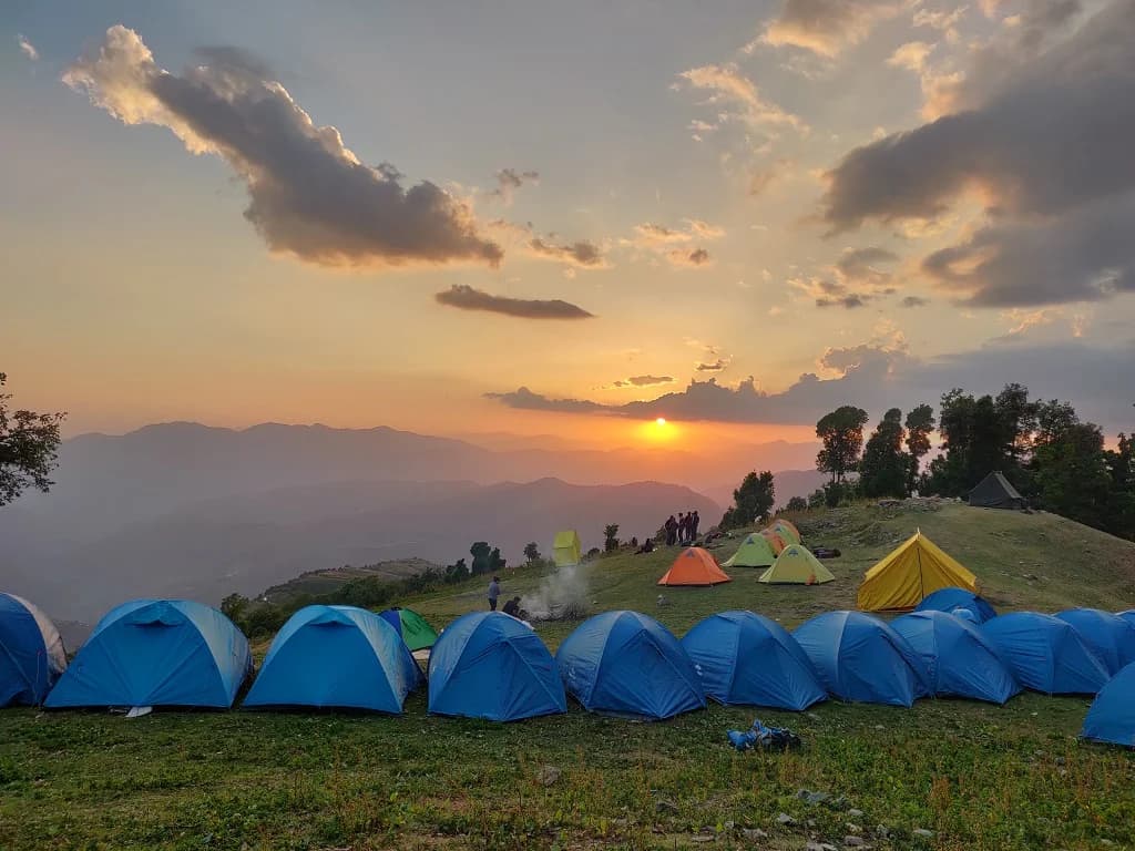 A first-timer campsite below Himalayan peaks, representing easy 2-day treks near Delhi