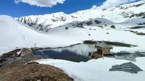 The sacred Yulla Kanda lake and Krishna temple at altitude in Kinnaur